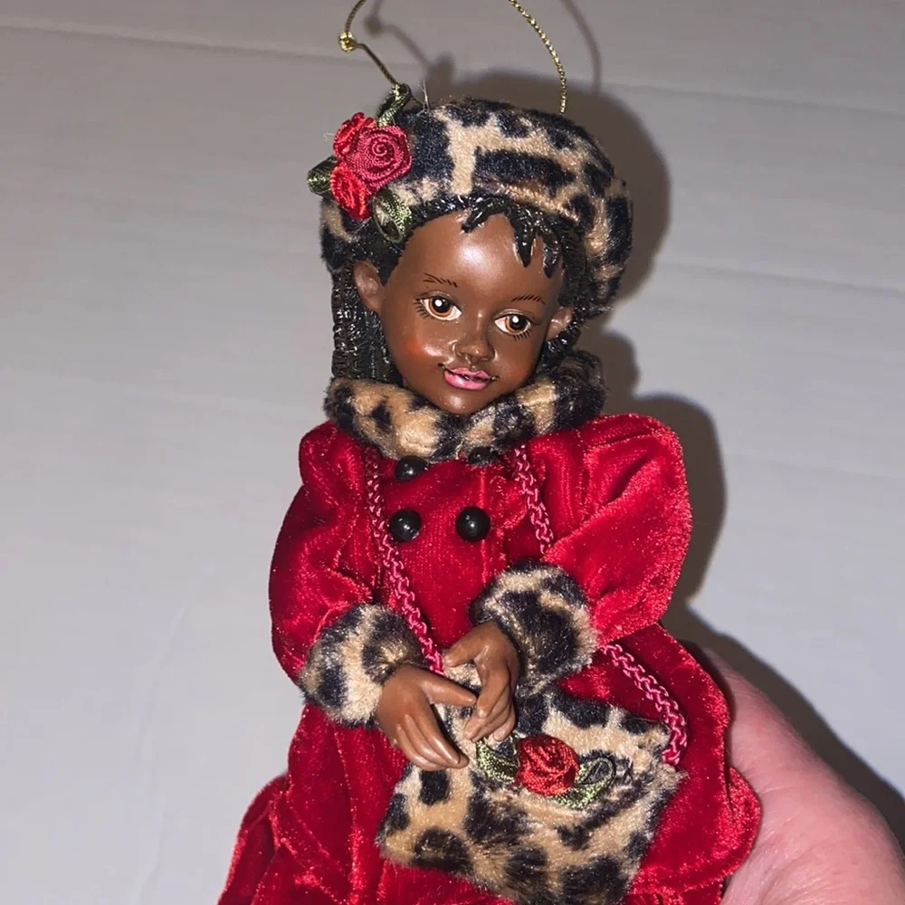 Vintage African American doll ornament with red velvet and leopard fur purse
