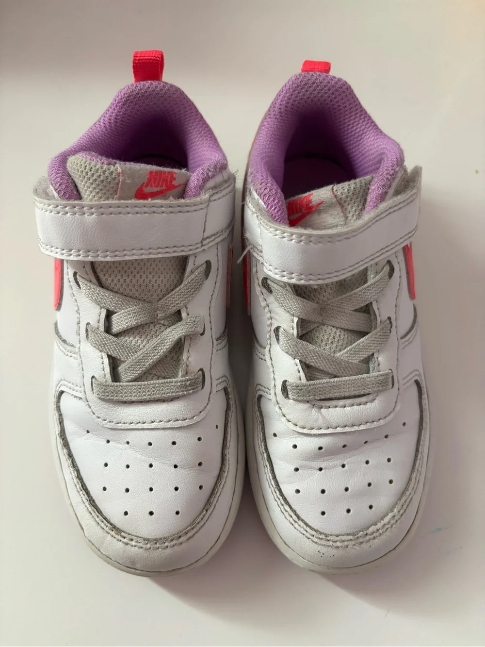 Nike White Sneakers with Bright Pink Swoosh and Lavender Soles