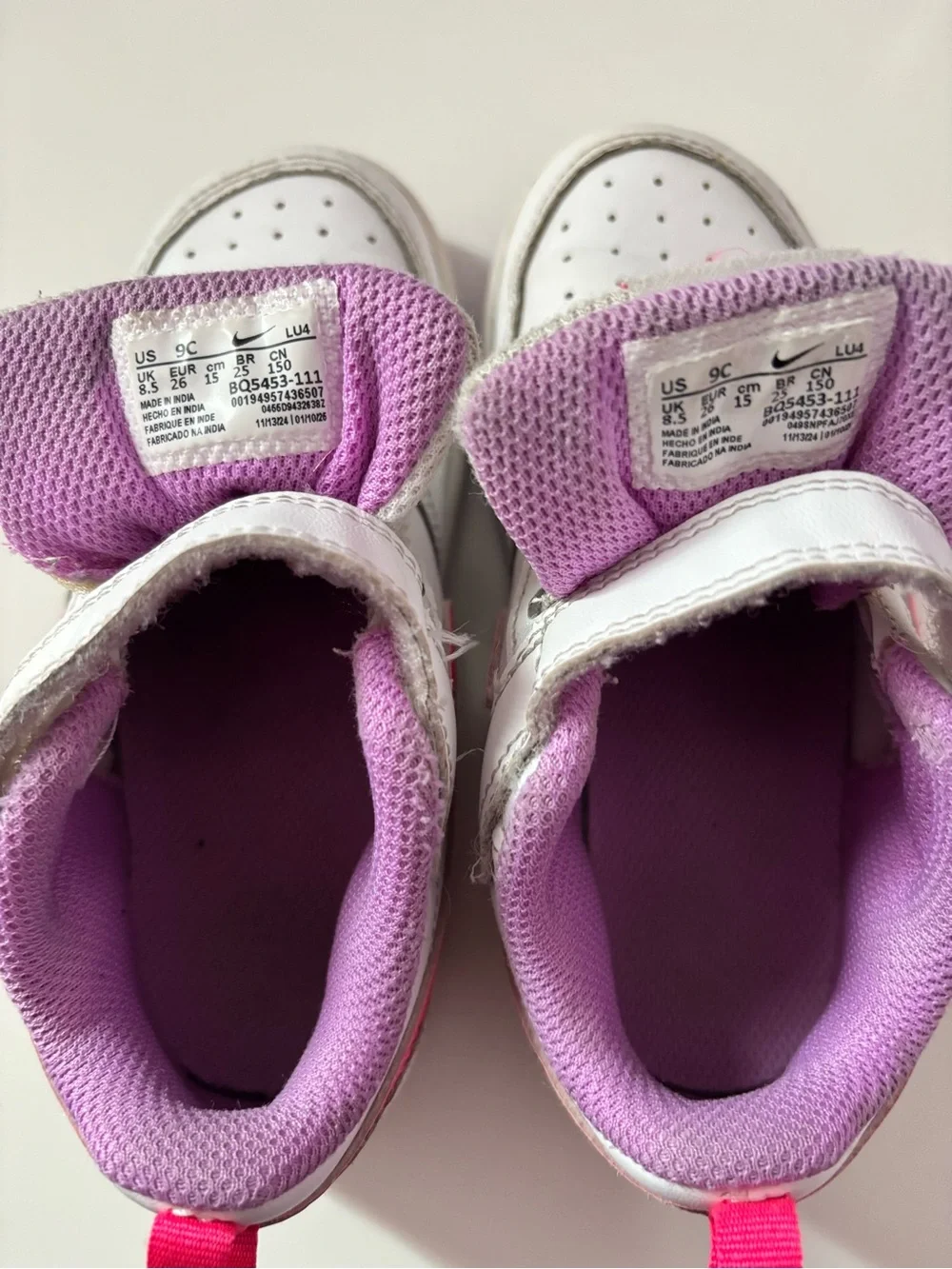 Nike White Sneakers with Bright Pink Swoosh and Lavender Soles