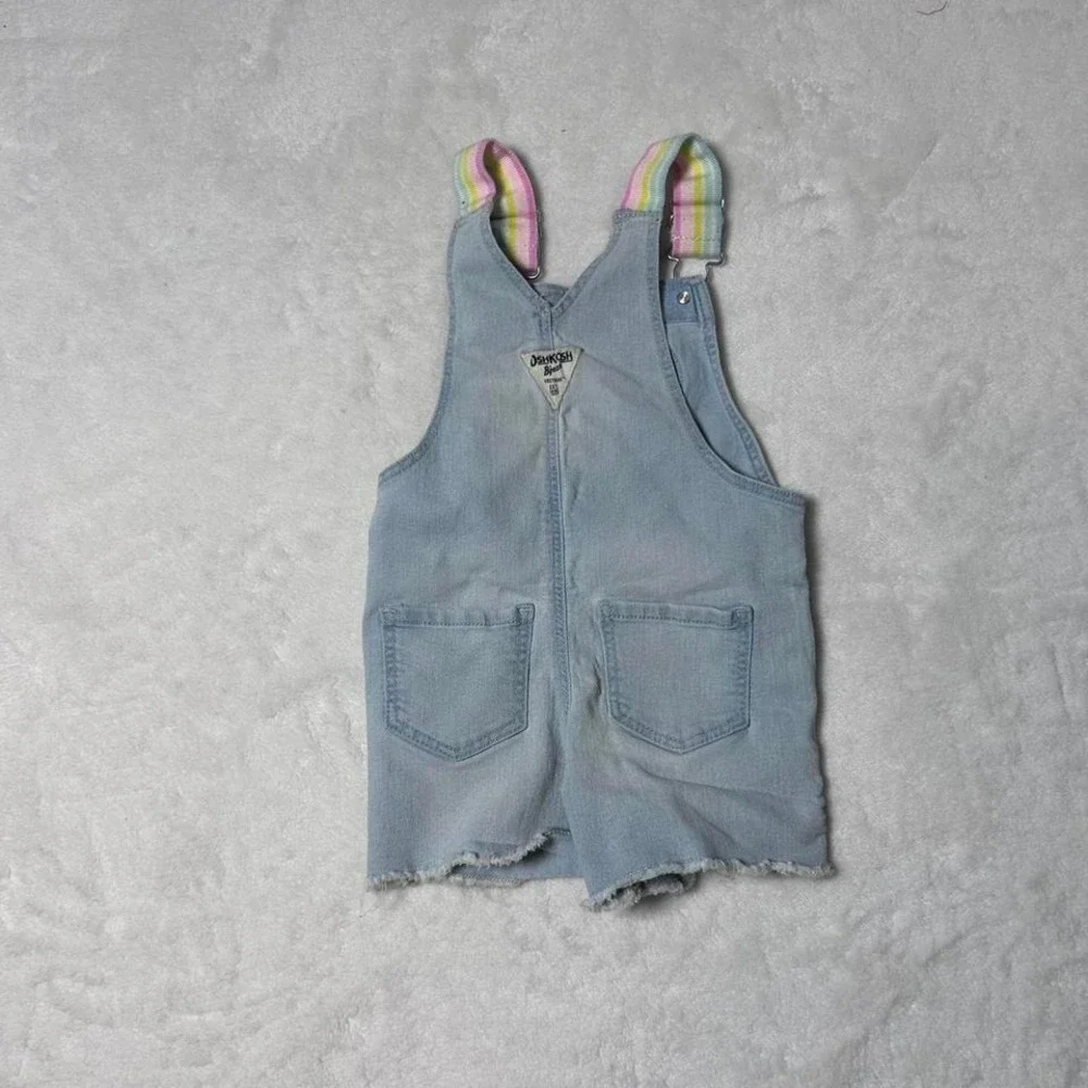 Blue denim shorts overalls‎ with heart detail and rainbow straps. Size: 2 years
