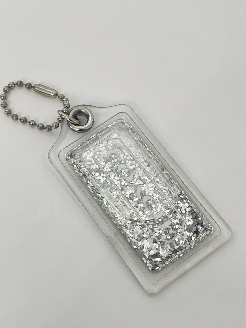 Coach Liquid Glitter Acrylic Hang Tag Clear | Silver