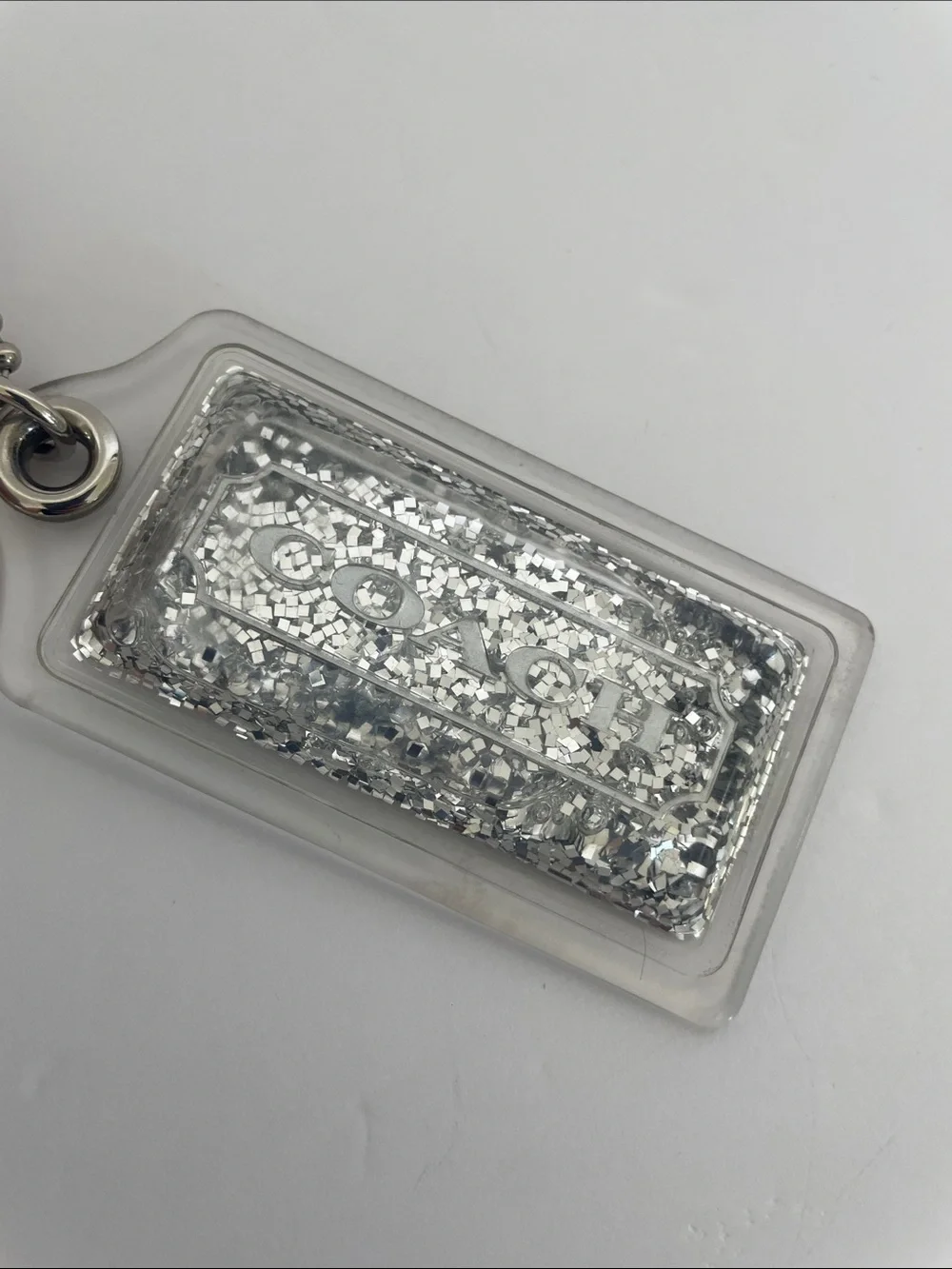 Coach Liquid Glitter Acrylic Hang Tag Clear | Silver