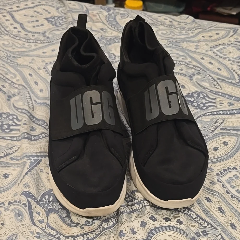 Like New UGG Black Slip-On Shoes with Logo Strap