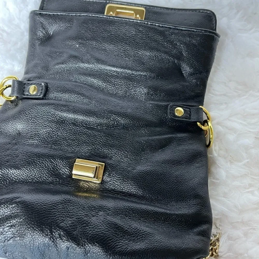 Paradox leather black small crossbody bag with ajustable gold tone chain.