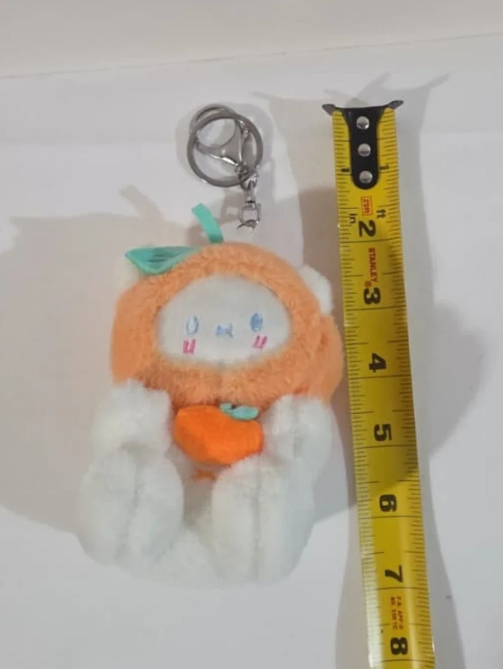white bear with orange hat plushie keychain