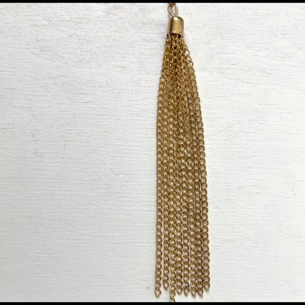 Gold tone long tassel necklace