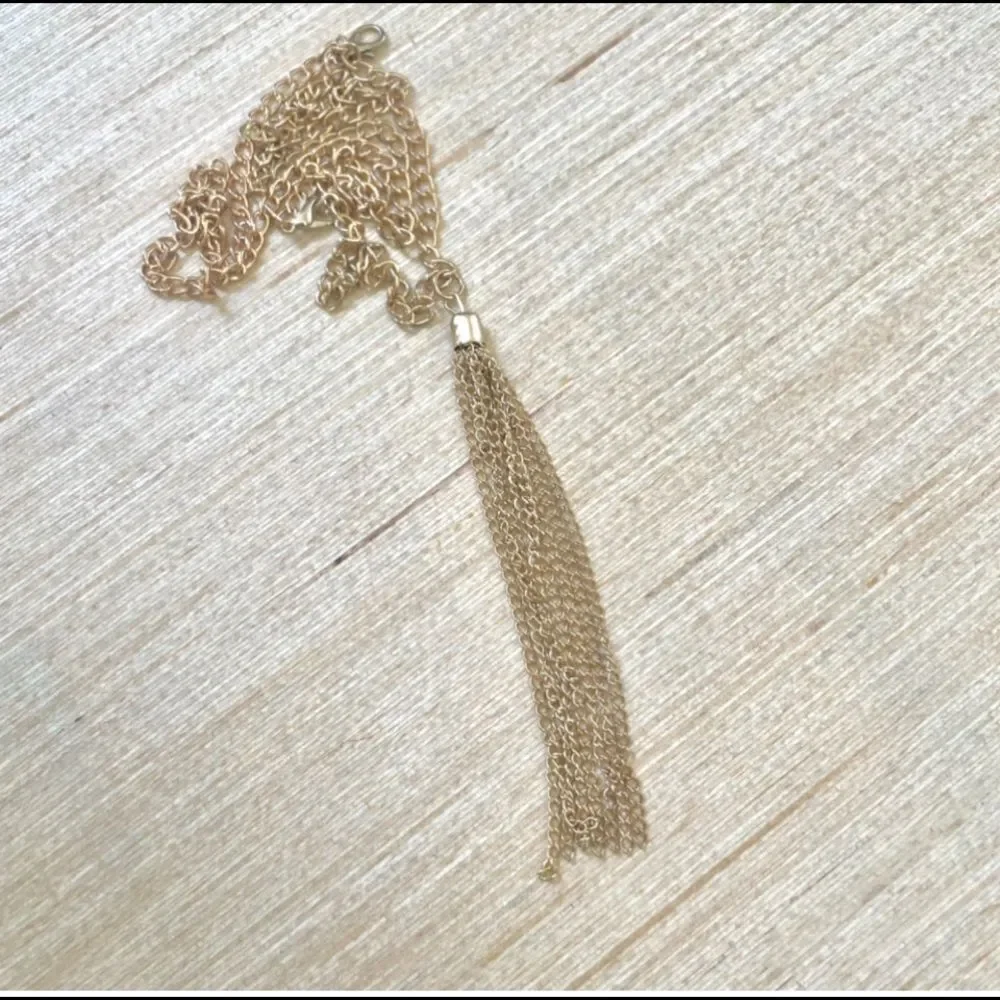Gold tone long tassel necklace