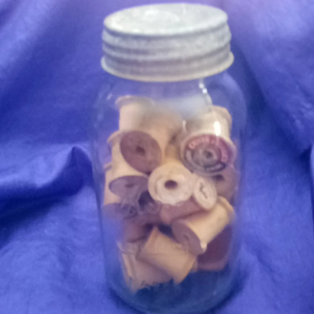 Vintage kerr Mason jar with 25 vintage wooden thread spools