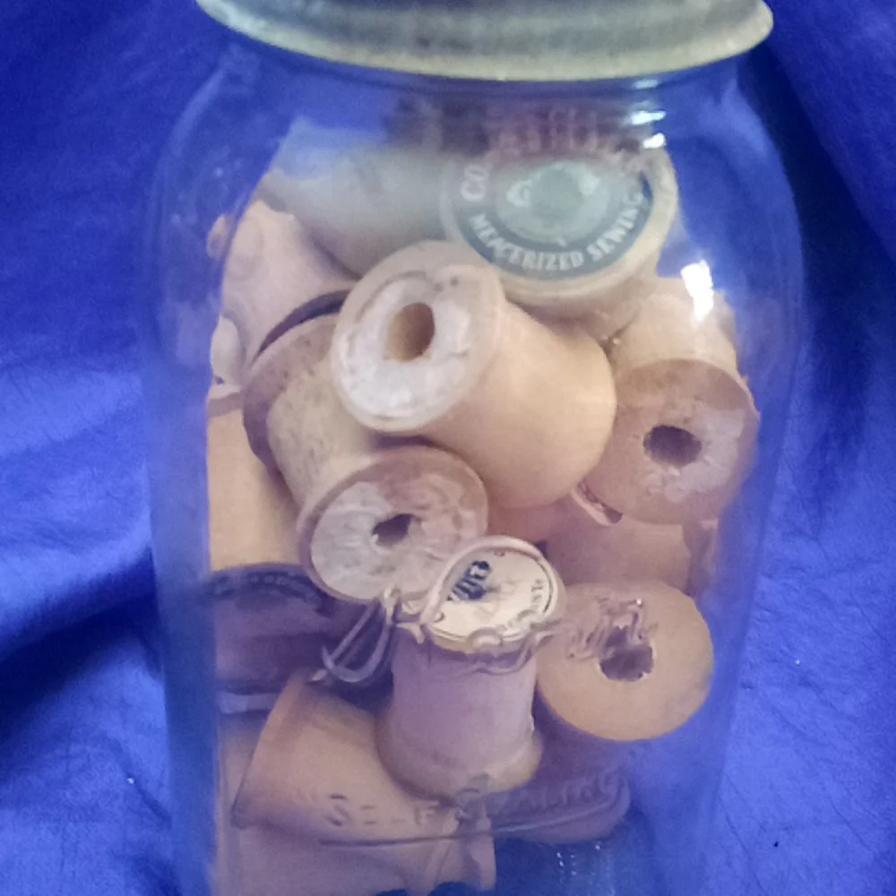 Vintage kerr Mason jar with 25 vintage wooden thread spools