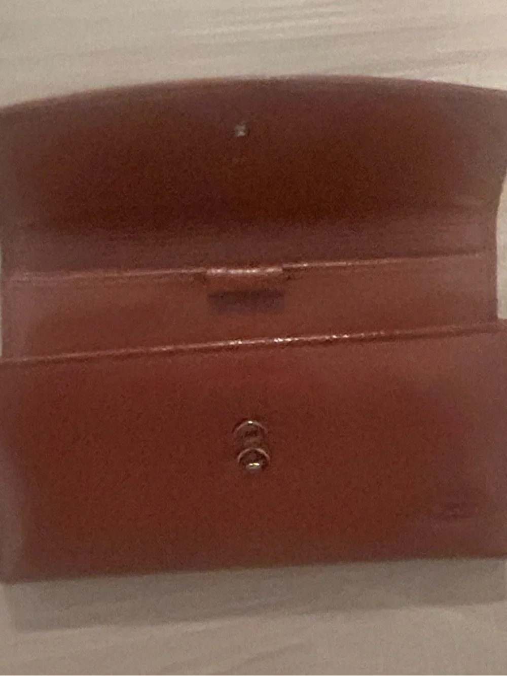 Rolfs brown leather card case with gold detail