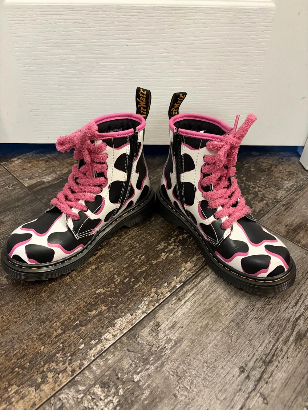 Dr Martin’s Black & White Cow Print Combat Boots with Pink Trim and Laces