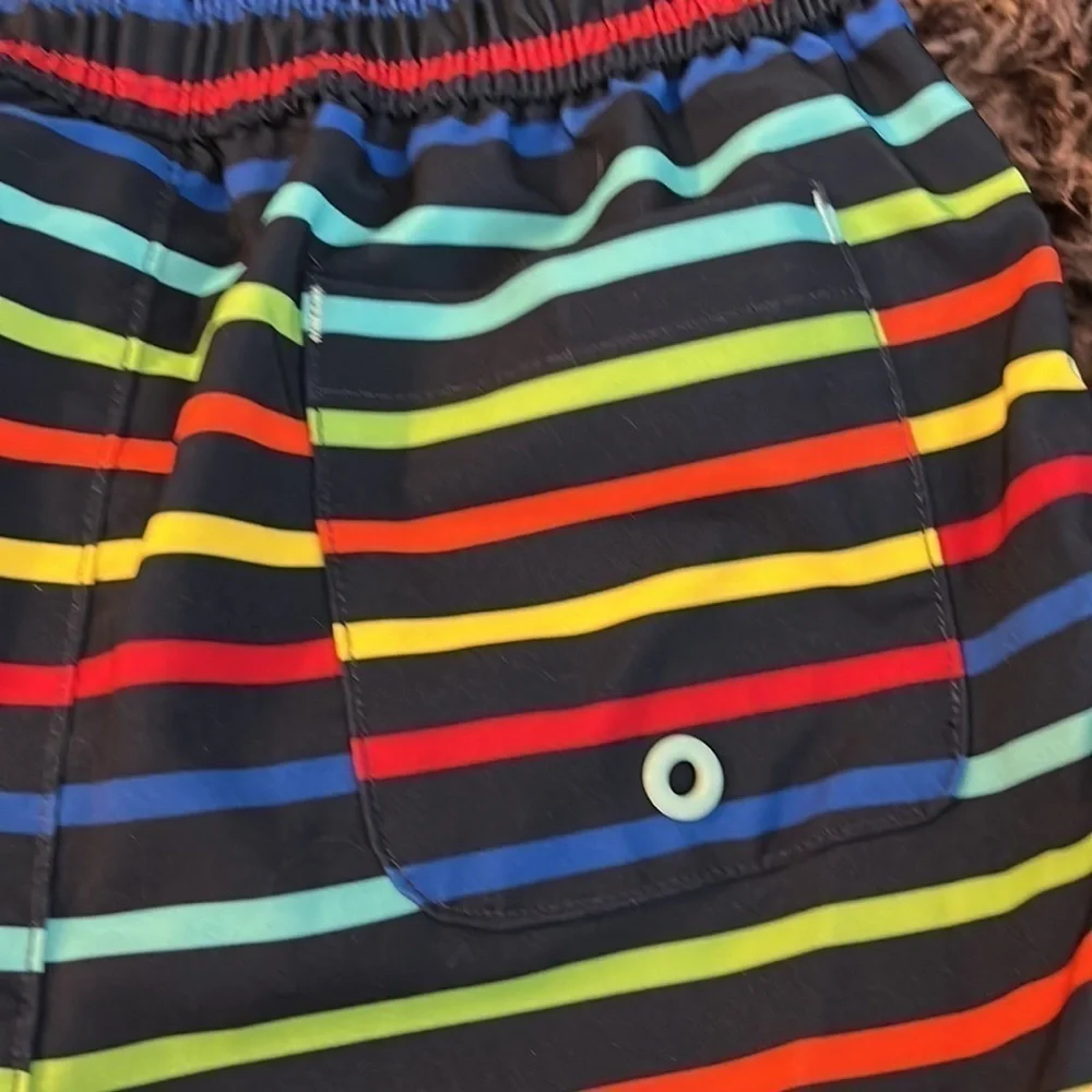 Wonder nation size 4T swim trunks.  Blue background with colorful stripes