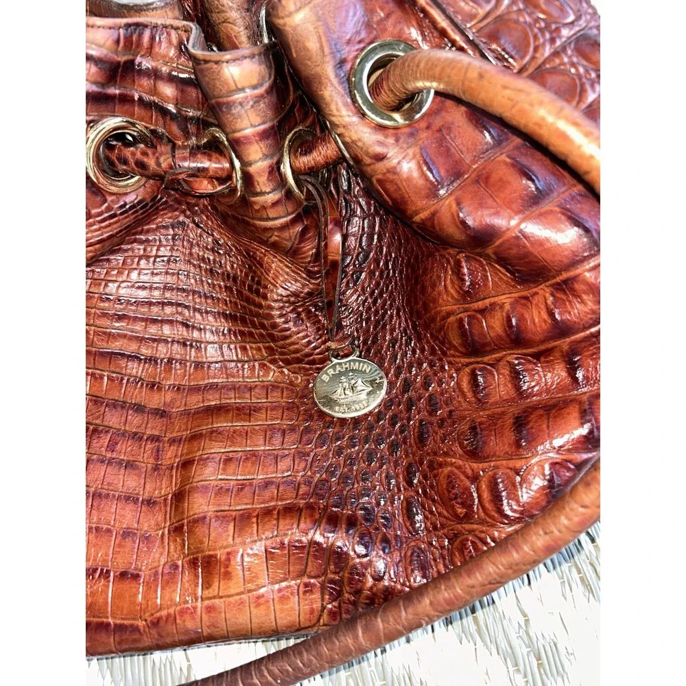 brown Brahmin bucket bag features croc-embossed leather