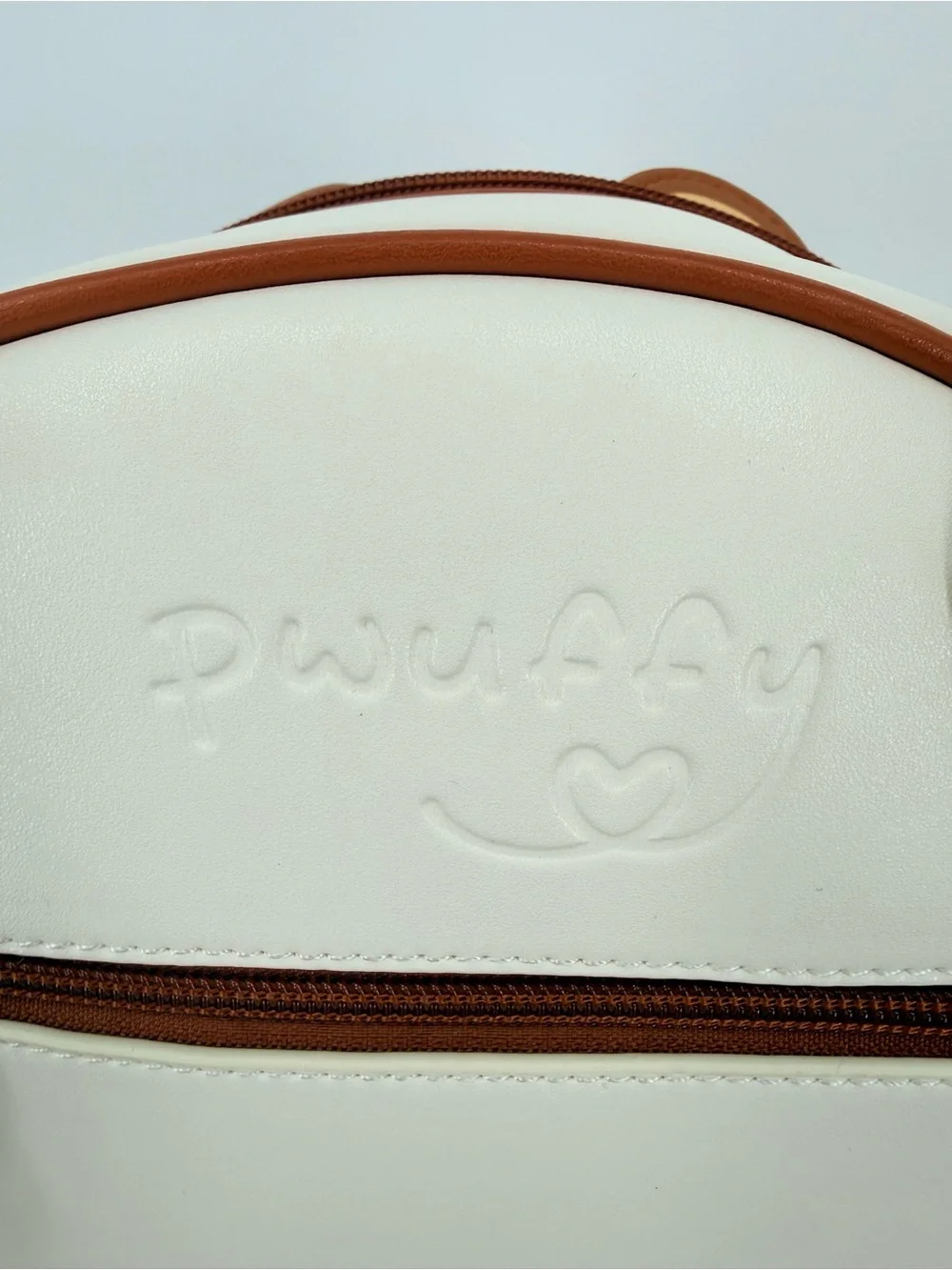 Pwuffy ring showcasing purse