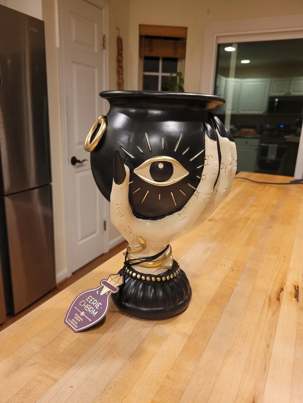 Eerie Charm Evil Eye Cauldron Held By A Witch's Hand - Black and Cream