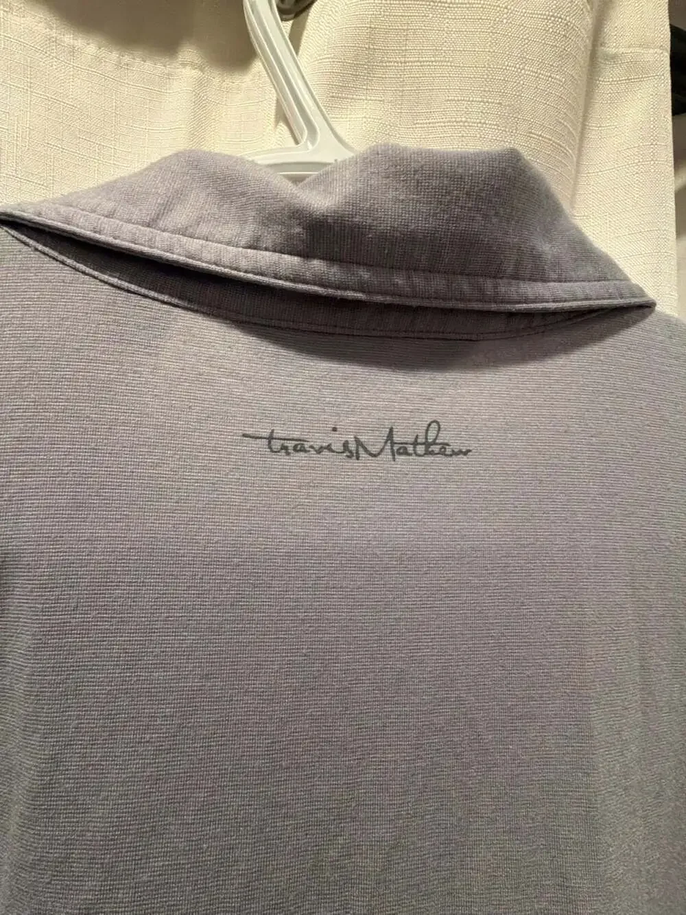 Travis Mathew pilling button