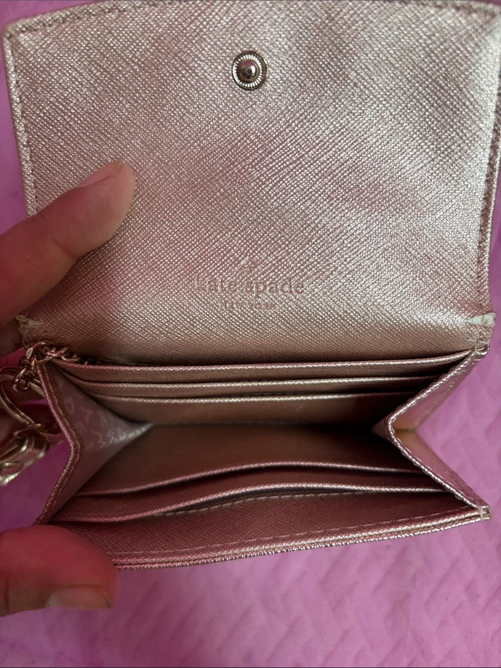 kate spade metallic rose gold wristlet card holder with tassel