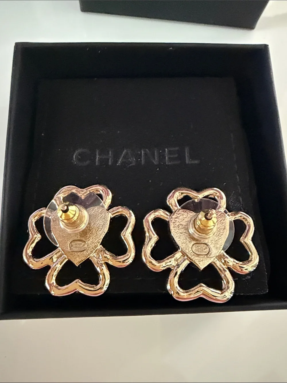 CHANEL earrings featuring