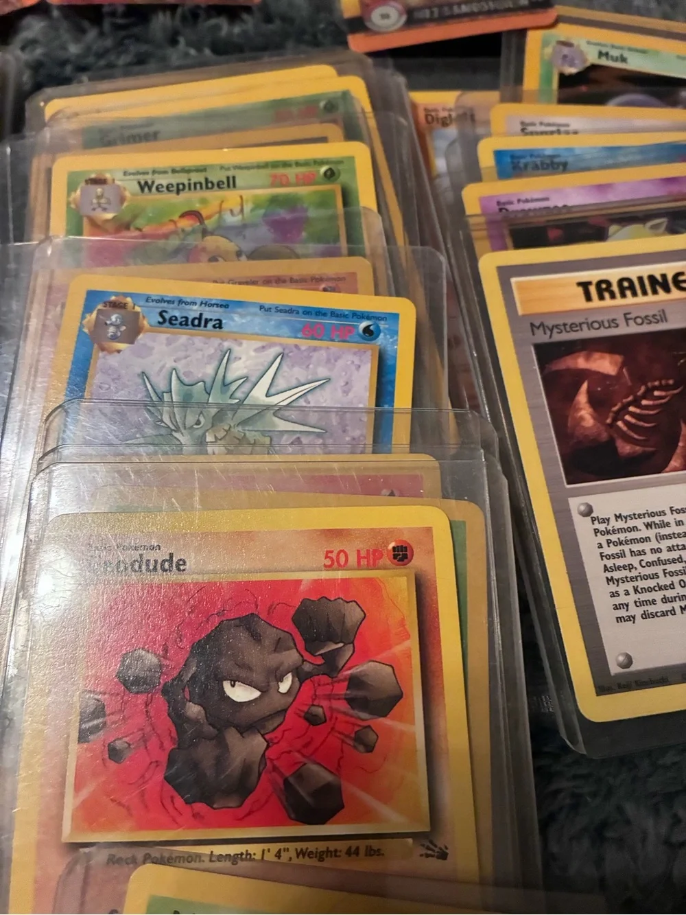 Pokemon Trading Card Lot - Assorted Colors 1997-98 trading cards in plastic hold