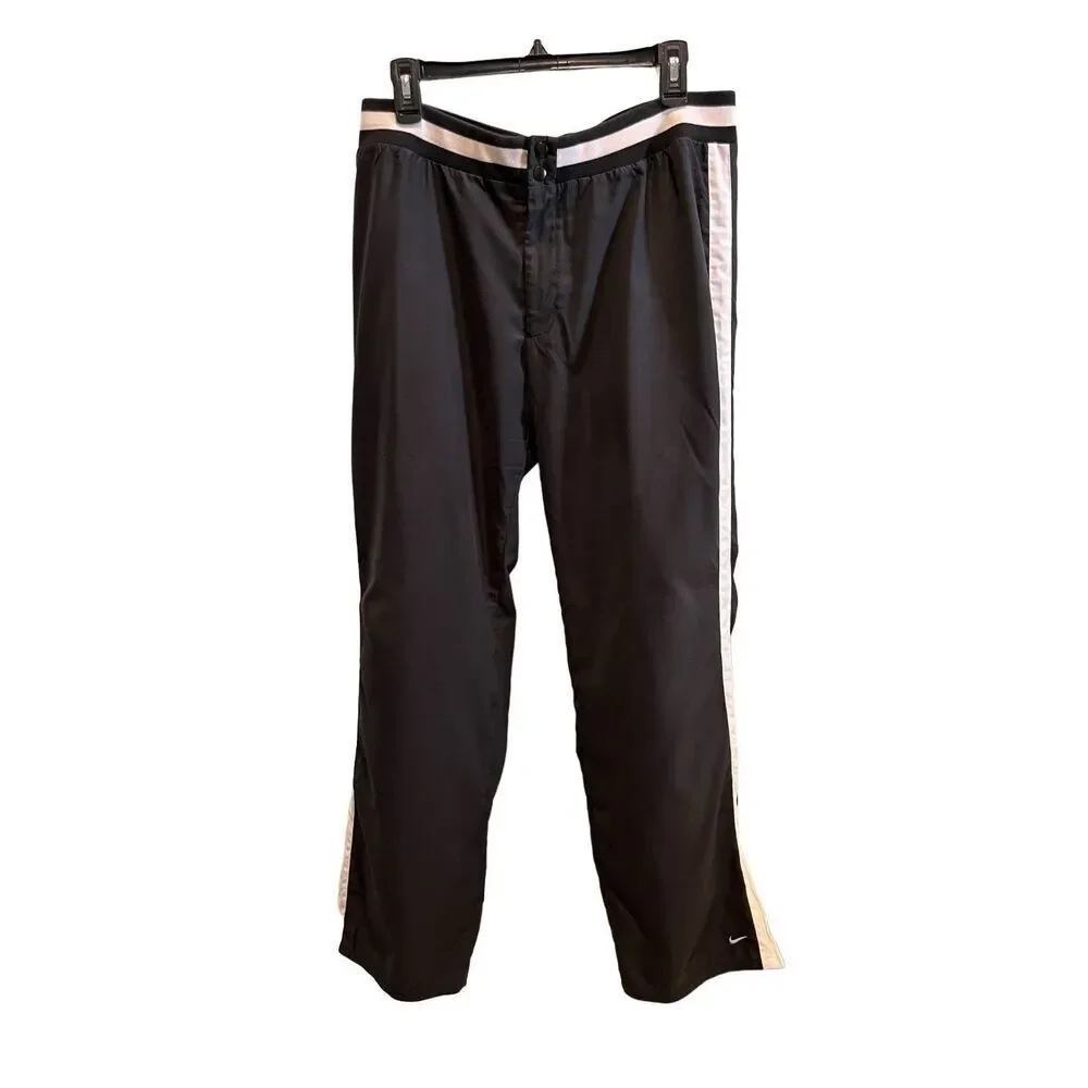 Nike black track pants with white side stripes and ankle zippers - L