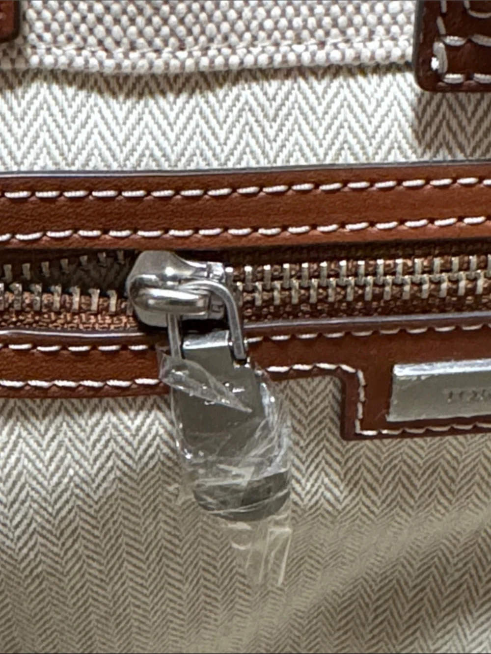 Tory Burch holds 15”