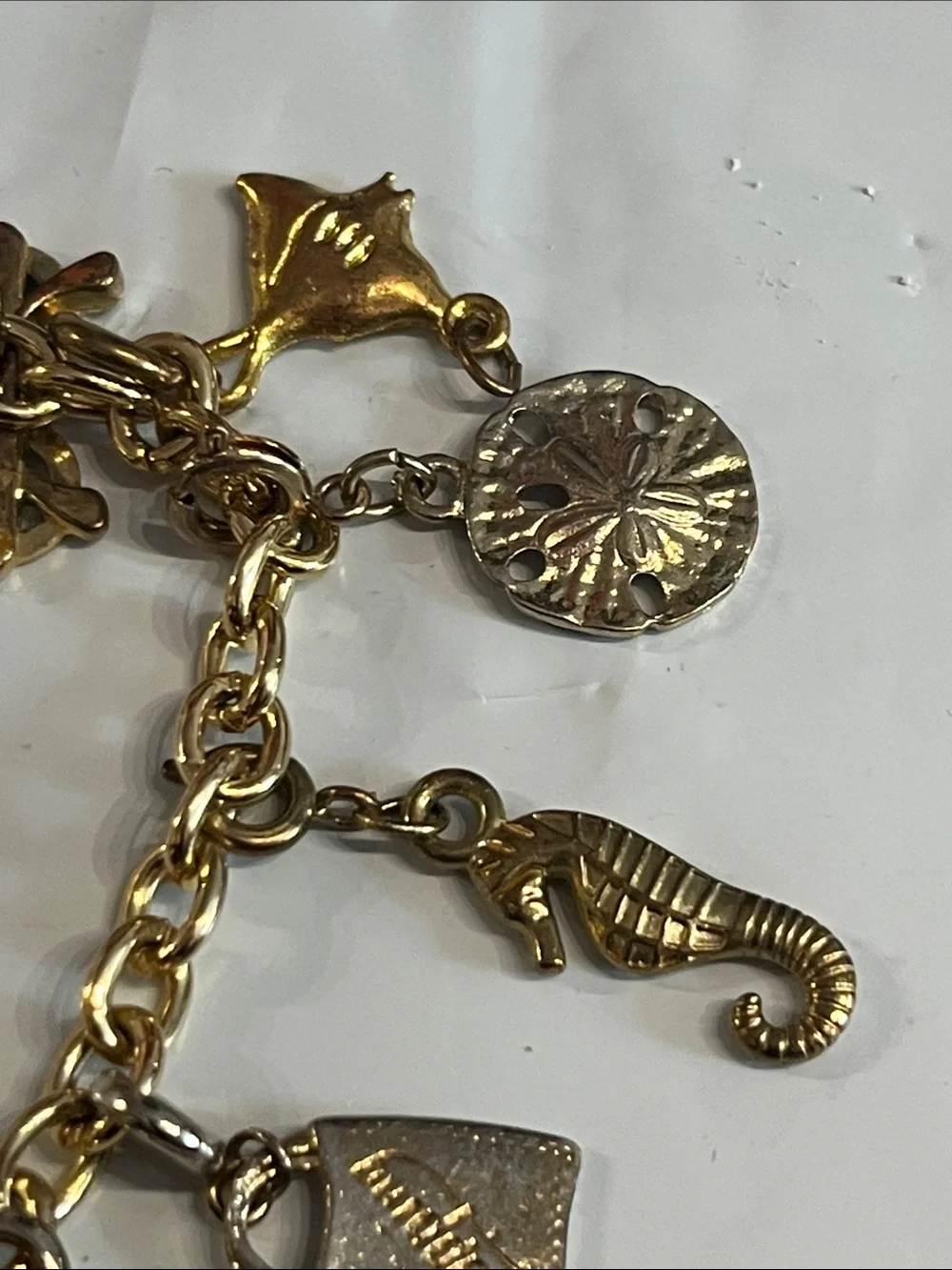 DIAMOND INTERNATIONAL GOLDTONE CHARM BRACELET