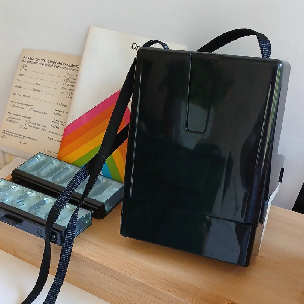 Vintage Polaroid Land One Step Instant Film Camera with Iconic Rainbow Design