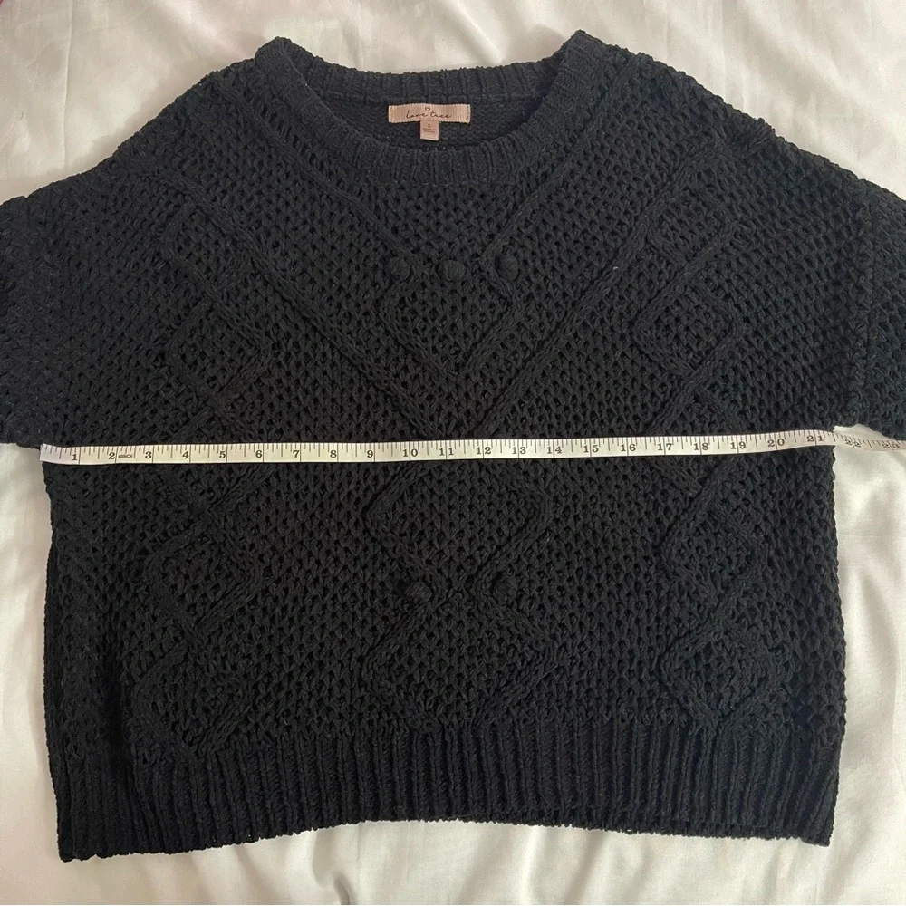 Black crew neck dropped shoulders ribbed trims knit sweater